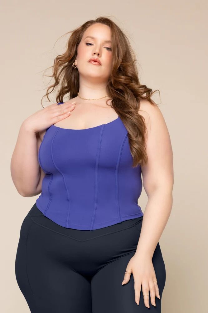 If fairytale princesses took workout classes, they’d all sport the Corset Cami. Designed with feminine corset details, this top can be effortlessly dressed up or down. Our fav feature? The adjustable shoulder straps. Compression Level: Performance Level: Stretch Sleeveless Corset With Bra-friendly Design, Stretch Sleeveless Corset Bra Friendly, Fitted Yoga Tops With Removable Bra Pads, Fitted Athleisure Tank Top With Adjustable Straps, Fitted Workout Tops With Removable Bra Pads, Stretch Corset With Corset Back And Tank Straps, Stretch Corset With Tank Straps And Corset Back, Corset Back Top With Tank Straps, Stretch Spaghetti Strap Top With Corset Back