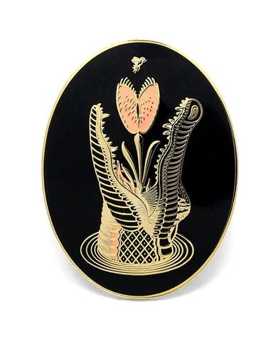 a black and gold plate with flowers on it