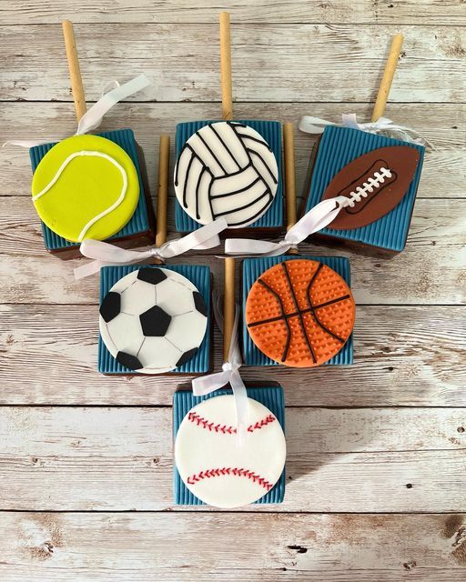 cupcakes decorated like sports balls on sticks