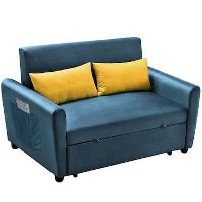 a blue couch with two yellow pillows on it's back and the seat up