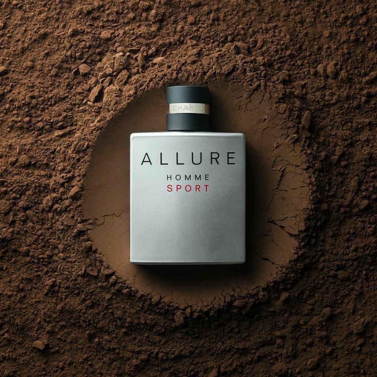 an allure perfume bottle sitting on the side of a dirt covered wall with it's lid open