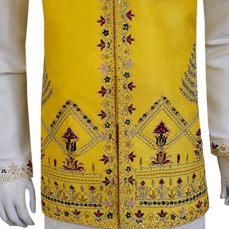 A handcrafted yellow designer waistcoat that elevates your look beyond compare. Crafted with meticulous attention to detail by skilled artisans, this waistcoat isn't just another import. It's a statement piece designed to turn heads at American mehndi celebrations. The vibrant yellow hue is a burst of festivity, while the premium quality fabric drapes effortlessly, ensuring a comfortable and sophisticated fit. Multicolor handwork adorns the waistcoat, each intricate detail a testament to the artistry behind this masterpiece. The exquisite craftsmanship is guaranteed to leave a lasting impression, making you the center of attention on your special day. Pair this stunning waistcoat with a classic white kurta pajama for a timeless mehndi ensemble that exudes sophistication. Customizable Perfe Fitted Yellow Kurta With Intricate Embroidery, Traditional Yellow Nehru Jacket For Festivals, Yellow Kurta With Intricate Embroidery For Festivals, Traditional Fitted Vest With Intricate Embroidery, Fitted Traditional Vest With Intricate Embroidery, Festive Fitted Vest With Intricate Embroidery, Yellow Kurta With Intricate Embroidery And Traditional Drape, Traditional Fitted Vest For Festive Occasions, Traditional Fitted Festive Vest