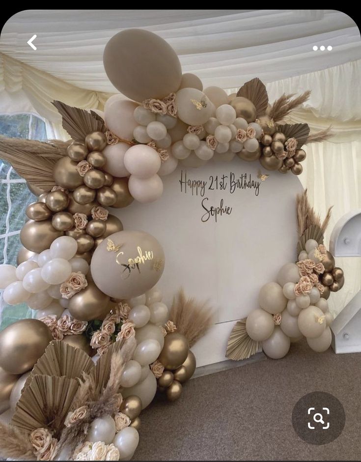 a happy 21st birthday sign surrounded by balloons and flowers in a marquee style