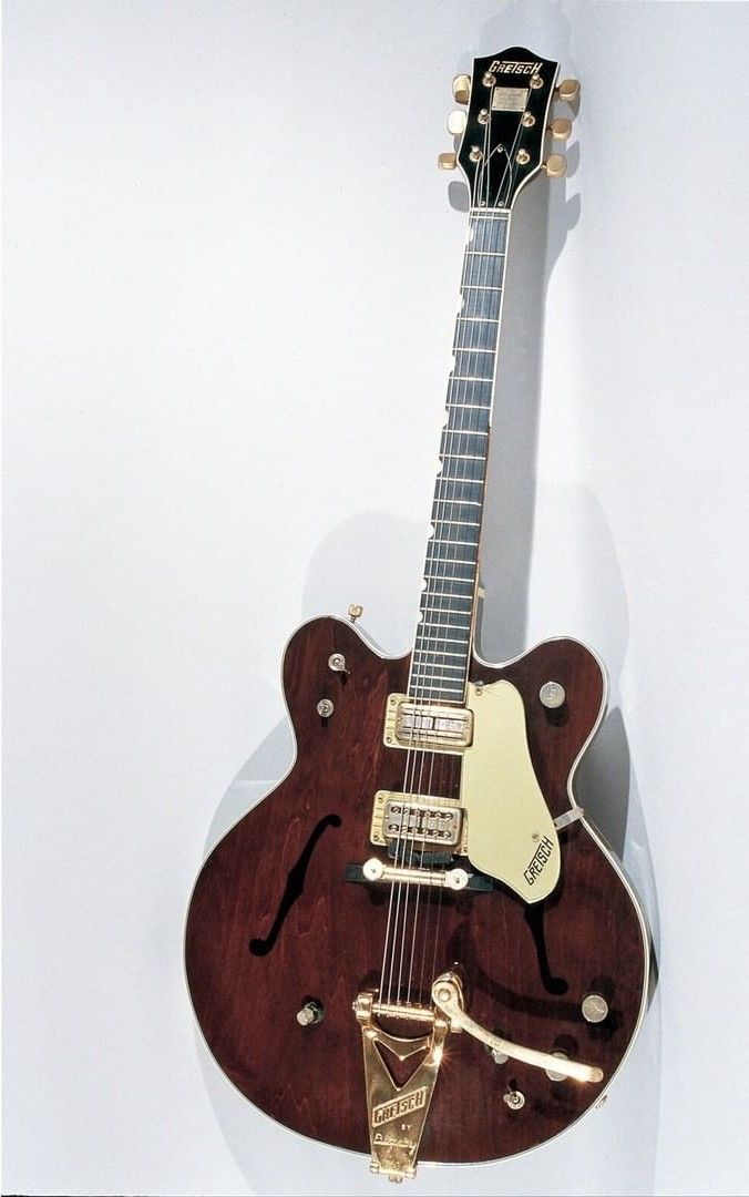 an electric guitar hanging on the wall