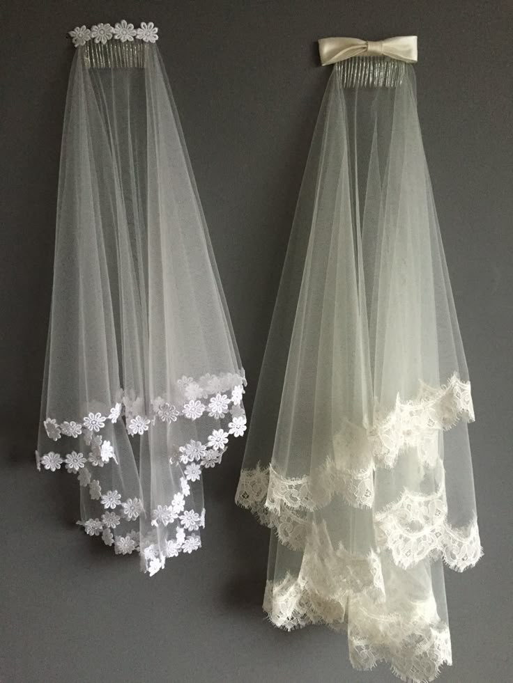 two wedding veils hanging on the wall