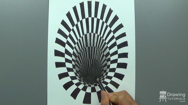 a person is drawing on a piece of paper with black and white lines in the center