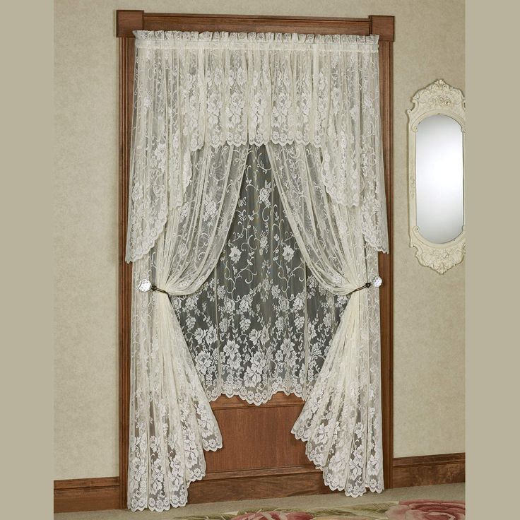 the curtains are hanging on the window sill in front of the mirror and rug