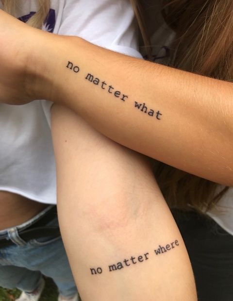 two people with tattoos on their arms that say no matter what they are doing,