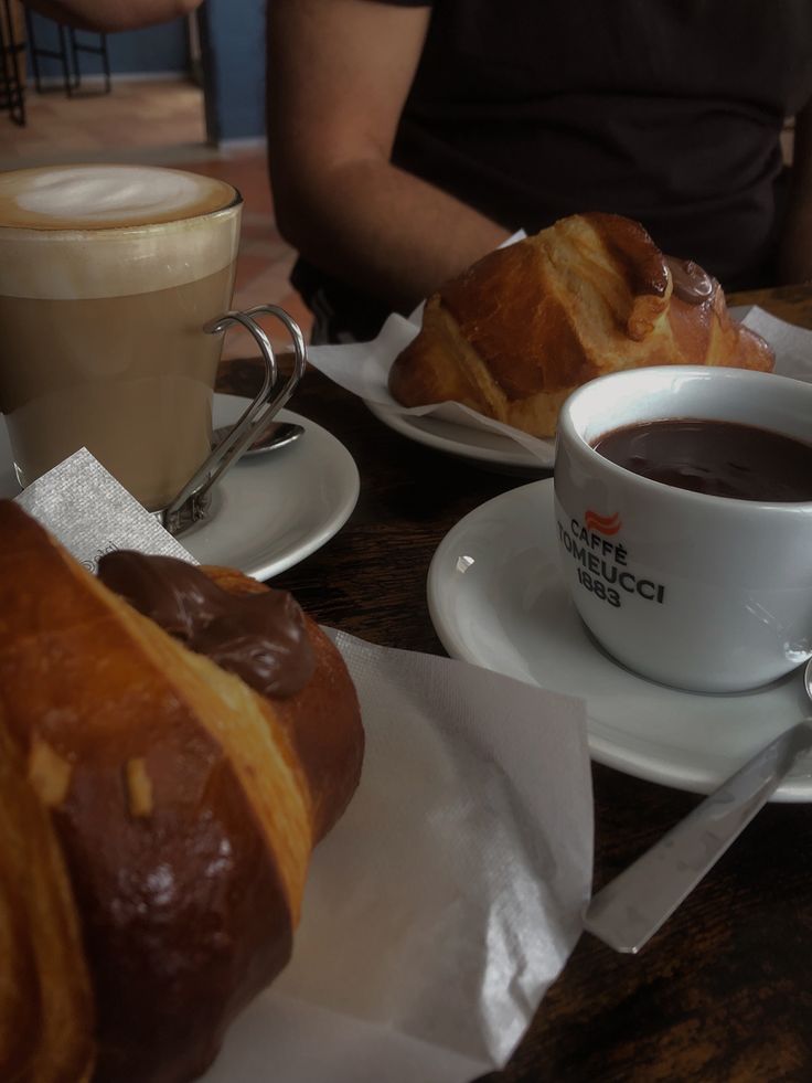 coffee and croissants are sitting on the table