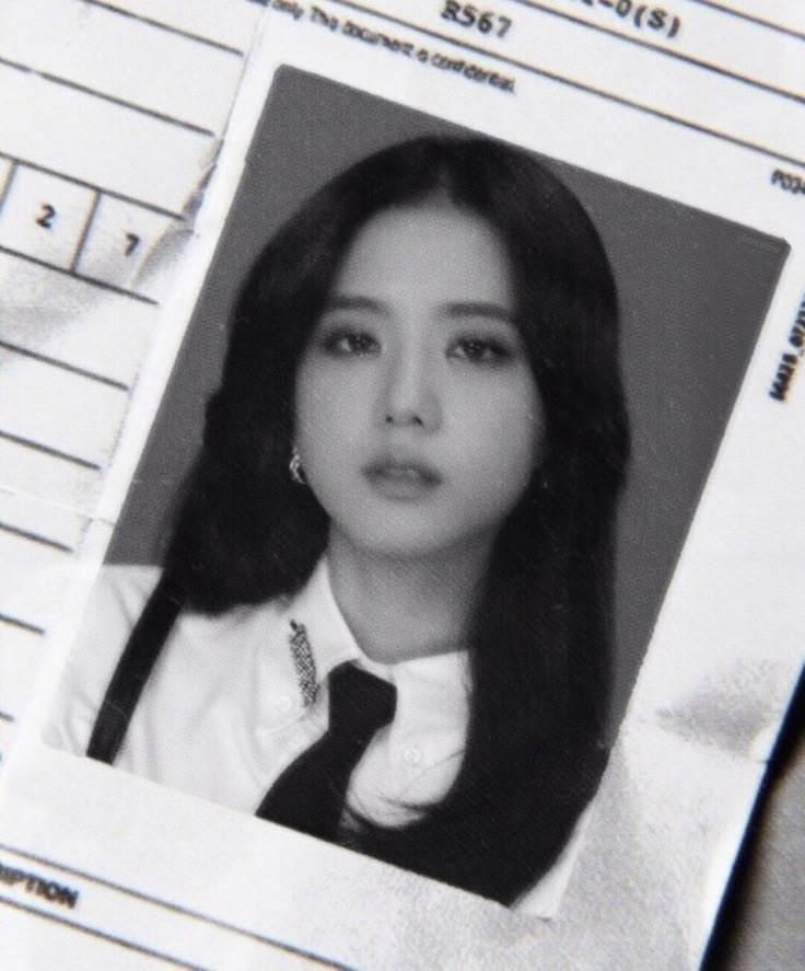 an old photo of a woman wearing a tie on top of a piece of paper