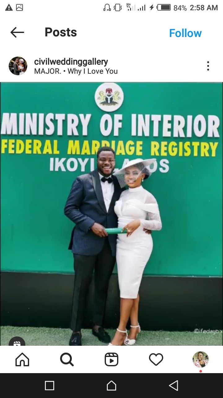 two people standing next to each other in front of a green and white sign that reads,