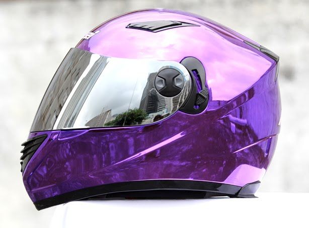 a purple helmet sitting on top of a white table