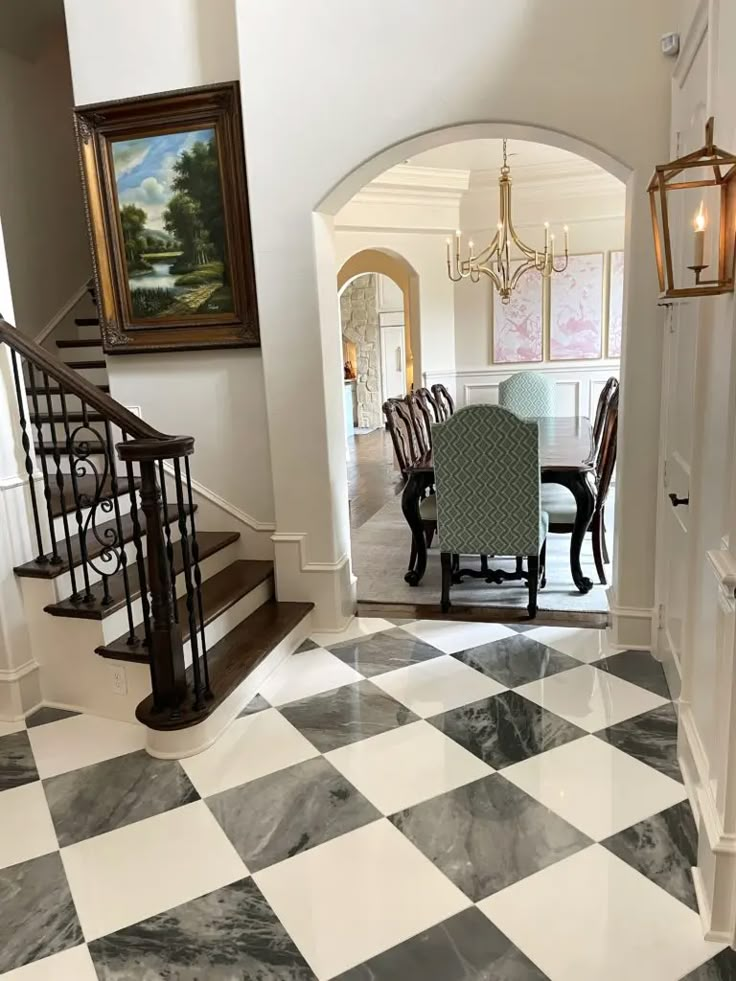 a dining room table and chairs are in the middle of a checkerboard floor