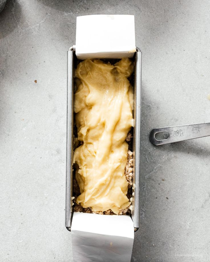 an open box filled with food sitting on top of a table next to utensils