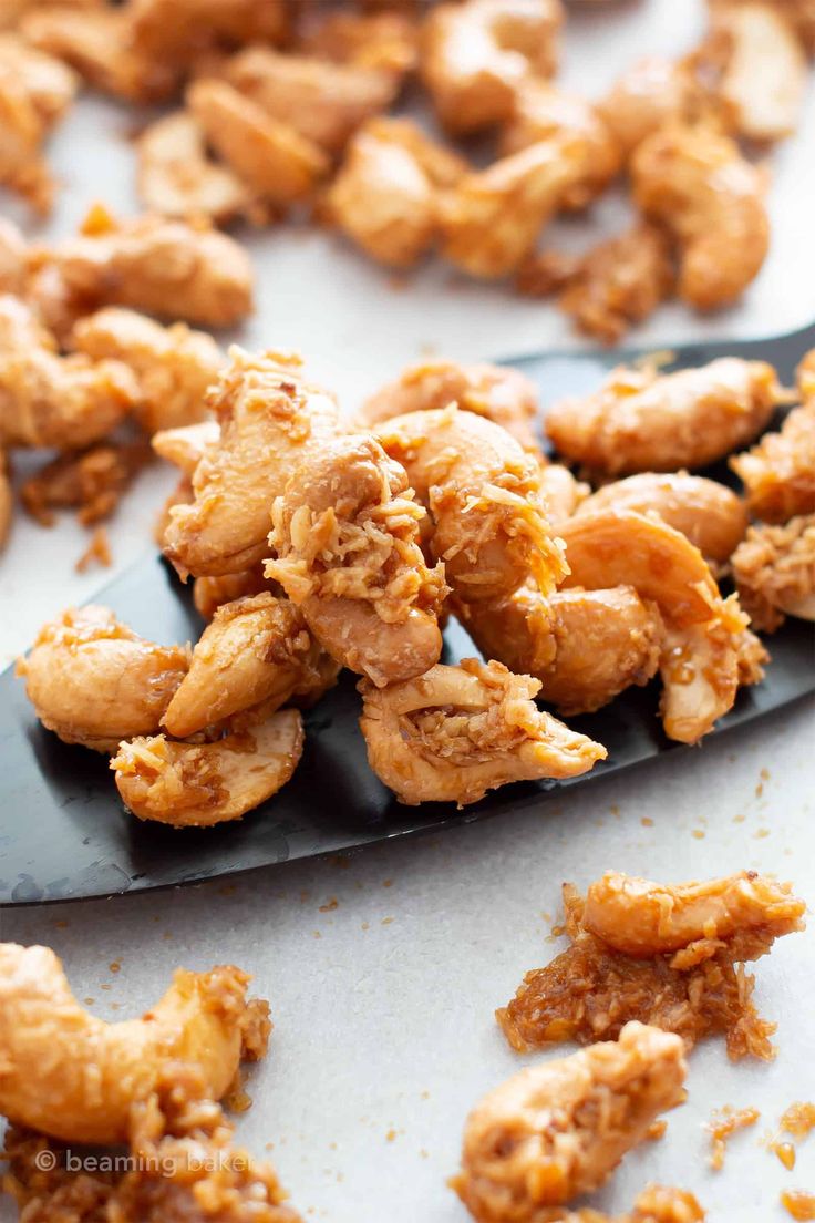 a spoon full of fried chicken sitting on top of a table