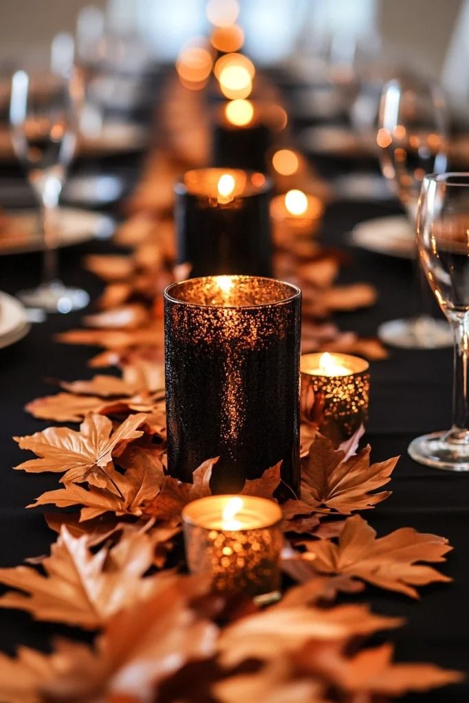 a long table with candles and autumn leaves on it, along with other place settings