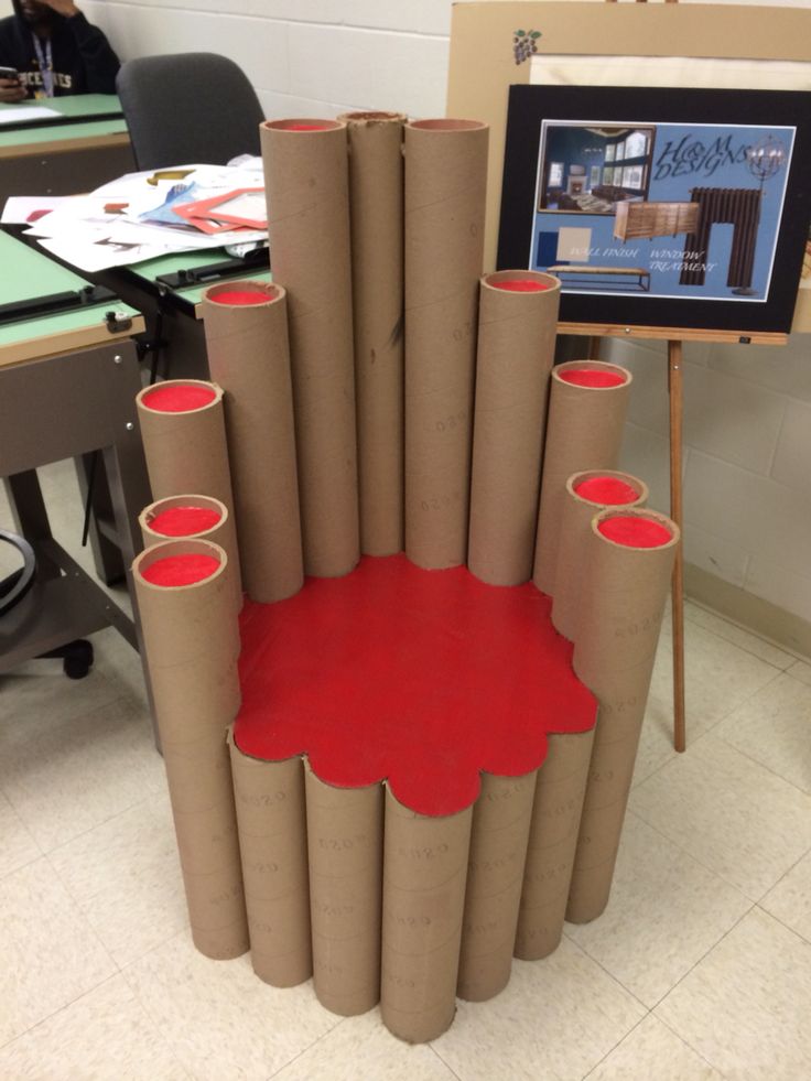 a chair made out of toilet paper with red paint on it