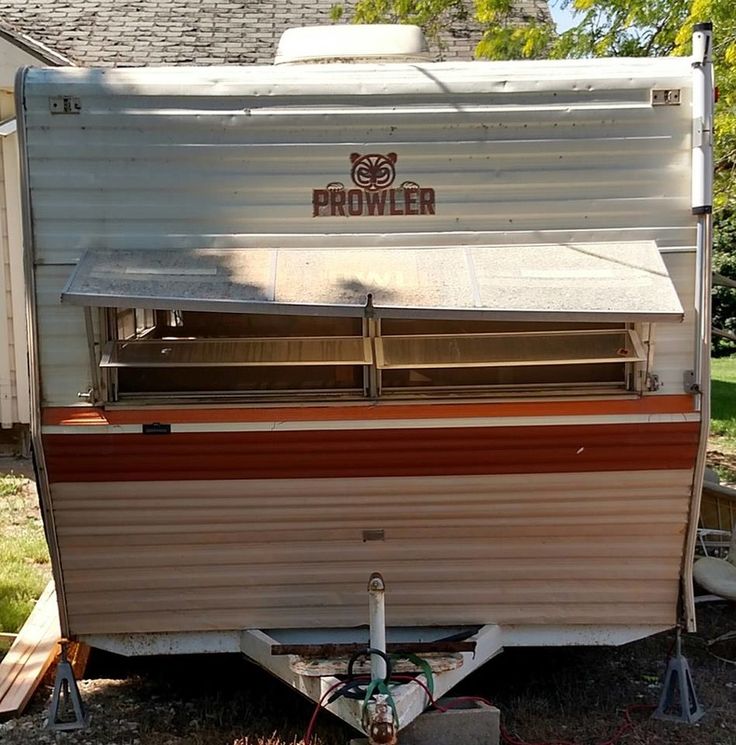 an old camper is parked in front of a house with the word prowl on it