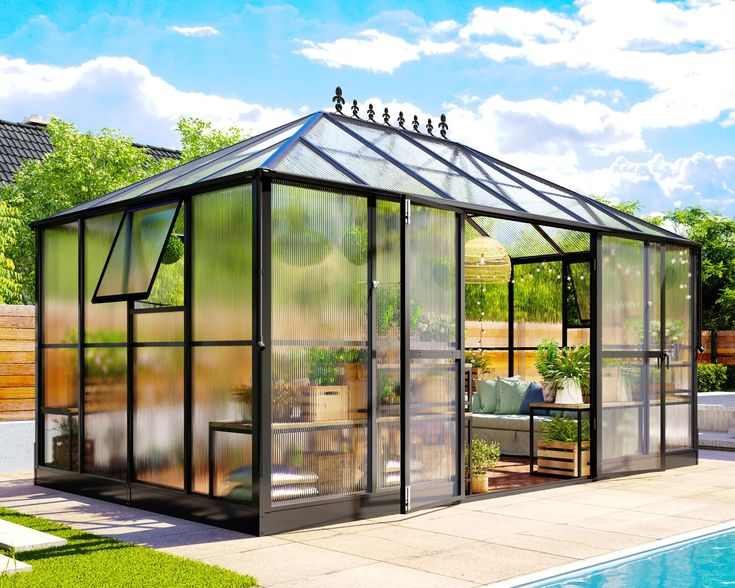 a glass house sitting next to a swimming pool