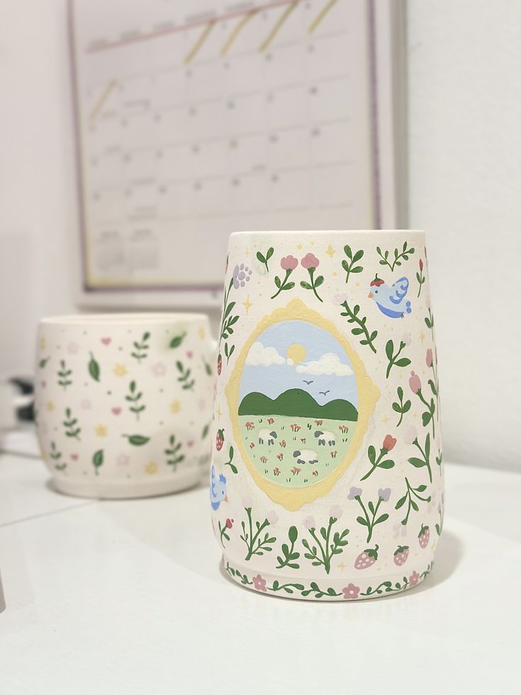 two mugs sitting on top of a white table