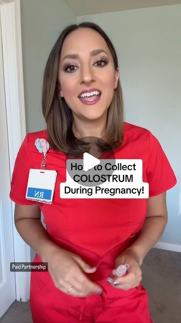 a woman in a red shirt is holding her id badge and smiling at the camera