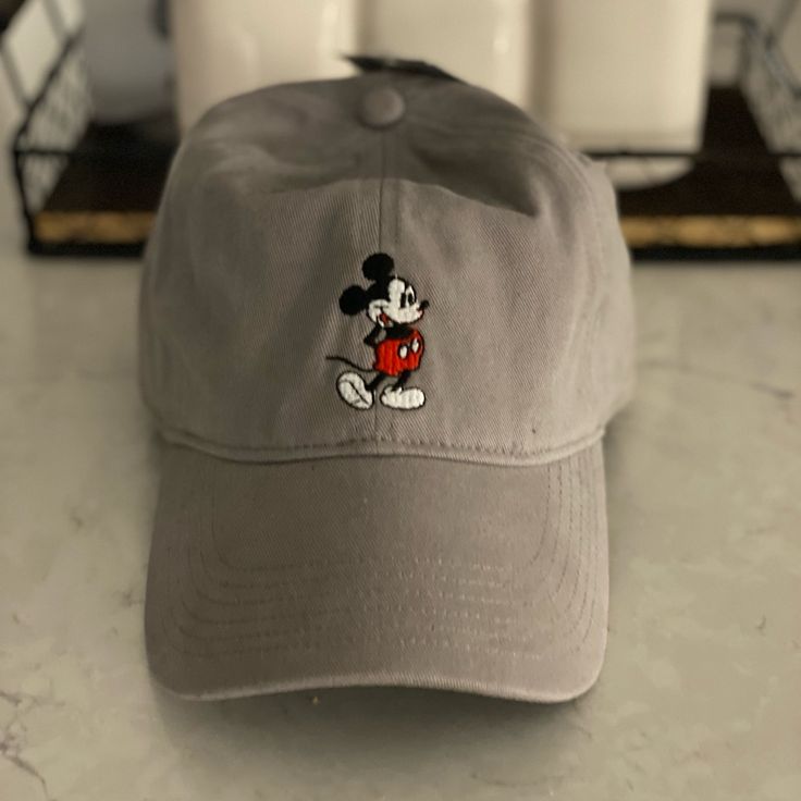 Bnwt Gray Mickey Baseball Cap. Simple Mickey In The Front Unisex Fun Mickey Mouse Themed Hat One Size Fits Most, Fun Mickey Mouse Hat, Sporty Gray Six-panel Baseball Cap, Casual Cotton Hats With Mickey Mouse Detail, Adjustable Mickey Mouse Fun Hat, Adjustable Disney Cap, Casual Cotton Mickey Mouse Hats, Disney Baseball Cap, Adjustable Cotton Mickey Mouse Hat