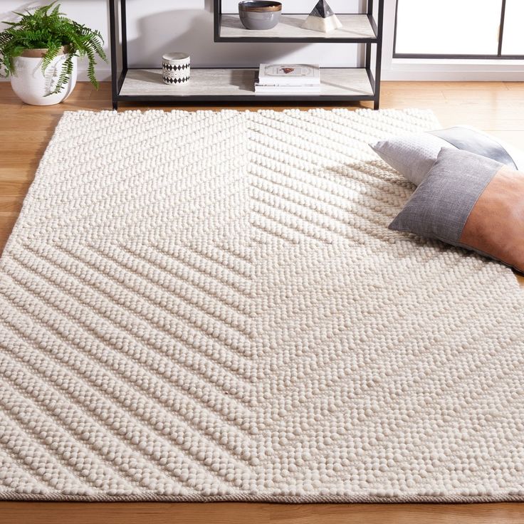 a person laying on top of a white rug