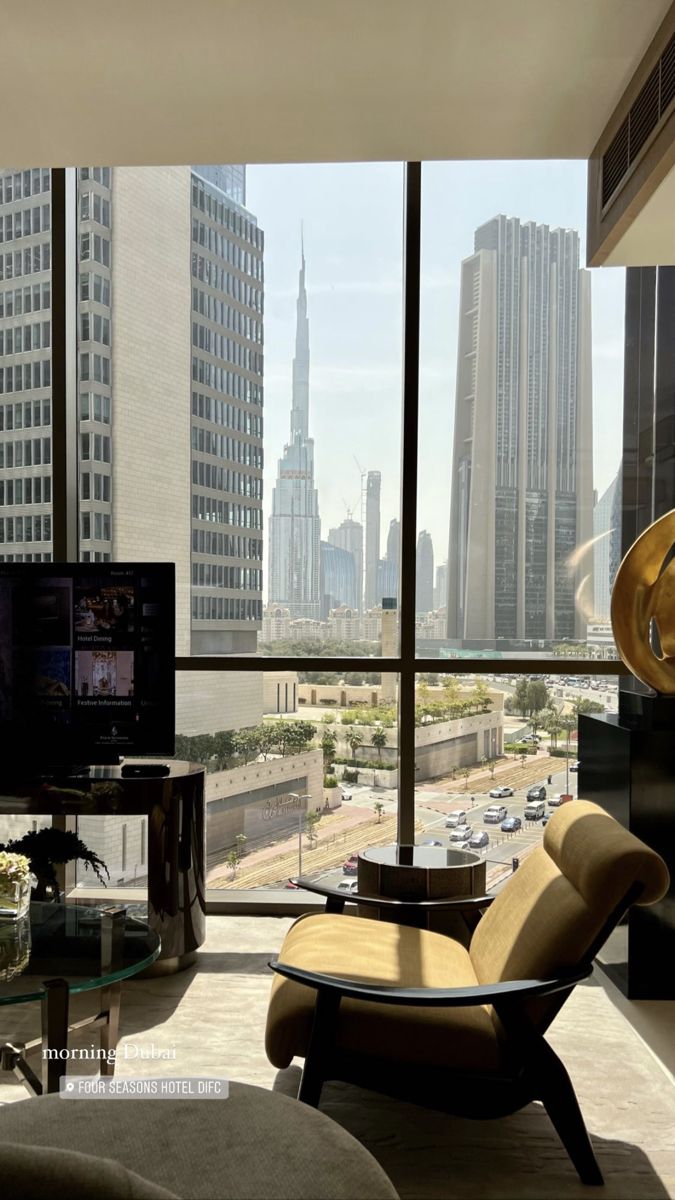 a living room filled with furniture and tall buildings