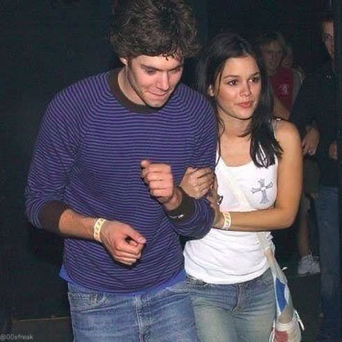 a young man and woman dancing together at a party