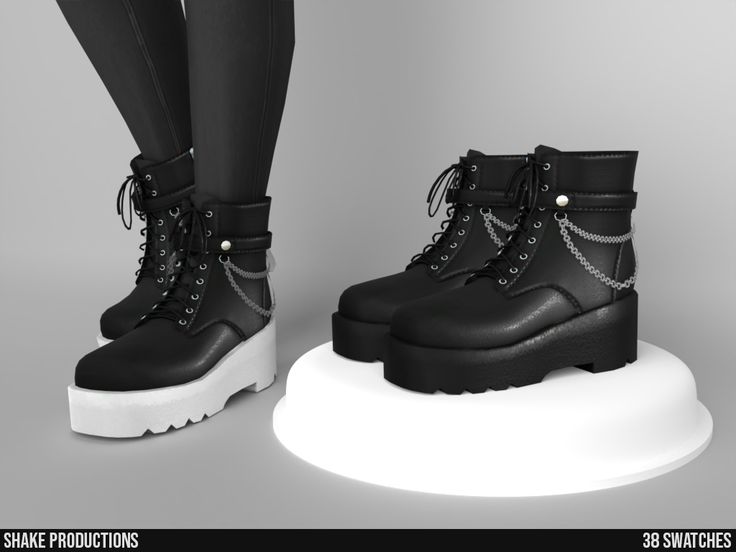 a pair of black boots with chains on the soles are standing next to each other