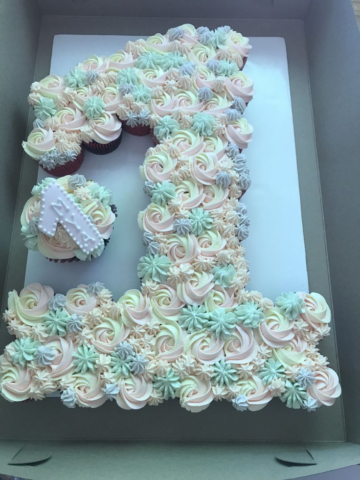 a box filled with cupcakes shaped like the number twenty five in frosting