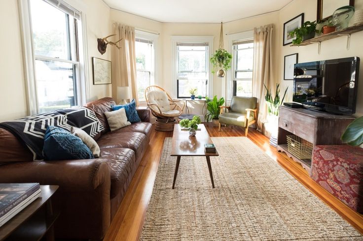 a living room filled with furniture and lots of windows next to a flat screen tv