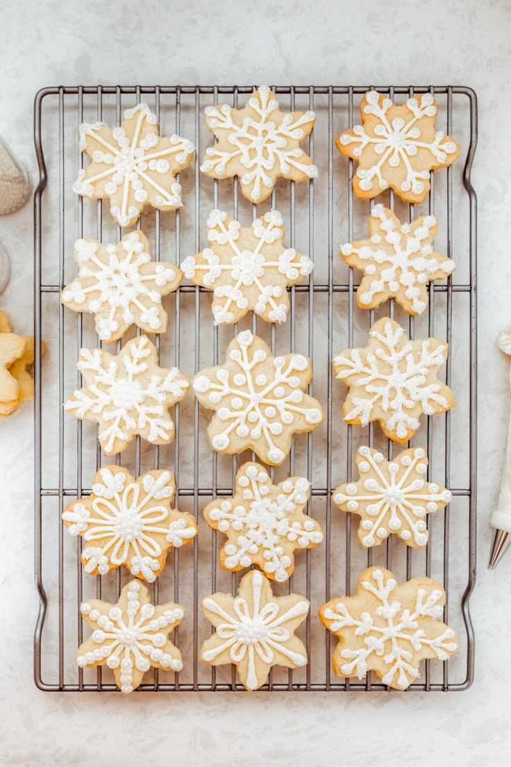 iced sugar cookies with white icing on a cooling rack