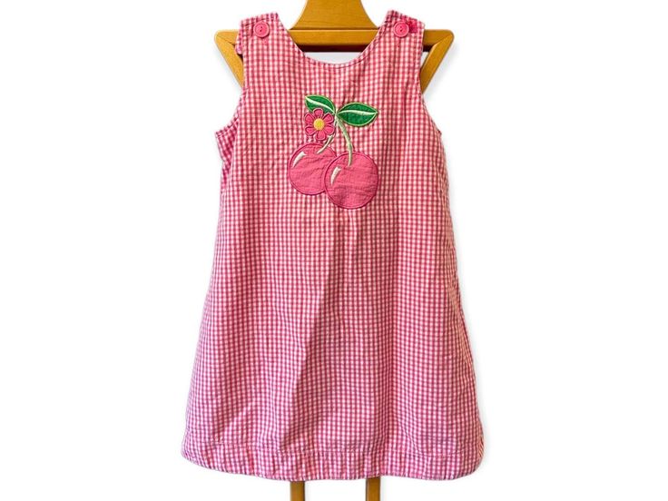 Vintage gingham pink cherry dress by UR It Embroidered cherry patch on chest Sleeveless￼￼ Pink gingham￼ Bow on back￼ ￼ 100% cotton￼ Front button closures￼ Small bow on one strap Brand is UR it Girls size 6￼ Measurements taken flat and are approximate￼ 13 1/2 inch bust￼ 16 inch hips ￼￼ 23 inch length Good vintage condition missing one bow on strap￼￼ Pink Cherry Print Dress For Summer, Pink Summer Dress With Cherry Print, Pink Cherry Print Summer Dress, Summer Pink Dress With Cherry Print, Cute Sleeveless Cherry Print Dress, Pink Cherry Print Dress For Spring, Spring Pink Cherry Print Dress, Toddler Party Dress, Cherry Dress