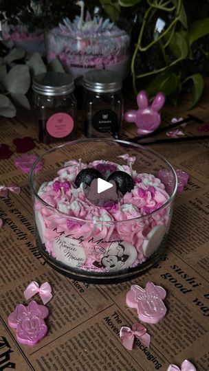 a bowl filled with lots of pink flowers on top of a table