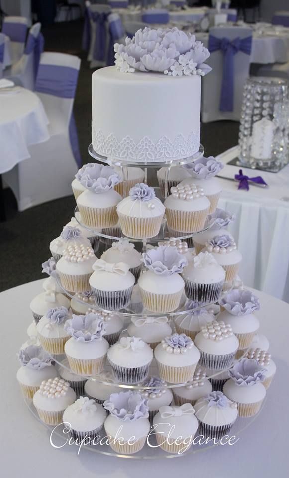 a wedding cake made out of cupcakes on a table