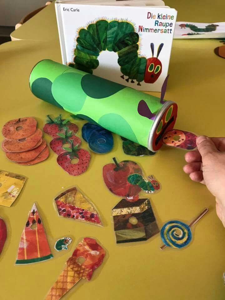 the very hungry caterpillars are on the table next to the book and stickers