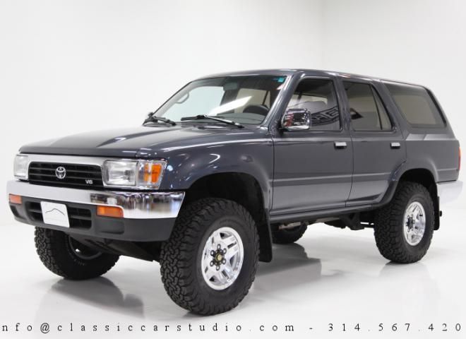 a gray toyota pickup truck parked in a white room