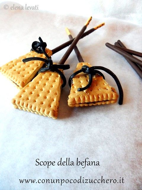 two pieces of crackers with black ribbon tied around them on top of white paper