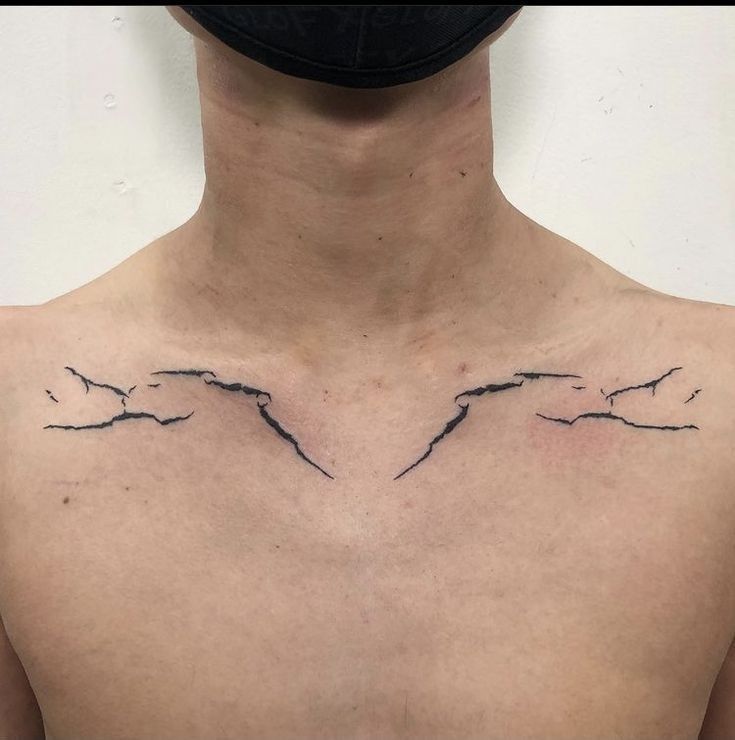 a man's chest with two birds on it