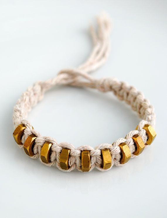 a bracelet with gold beads on it