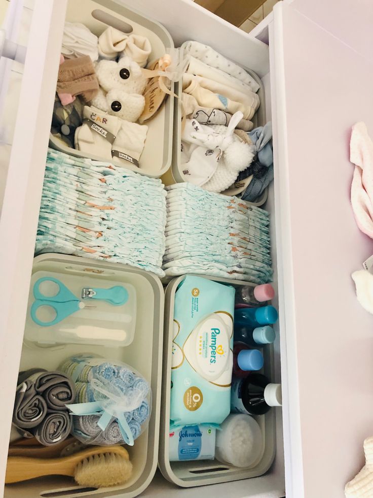 an organized drawer filled with baby items