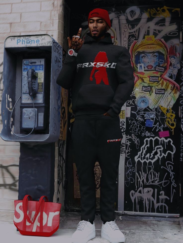 a man standing in front of a parking meter wearing a black sweatshirt and sweatpants