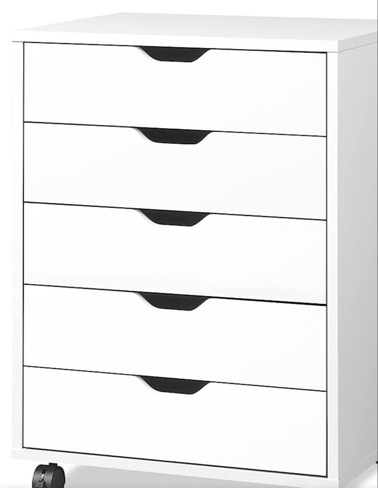 a white dresser with four drawers on casteors and black handles, against a white background