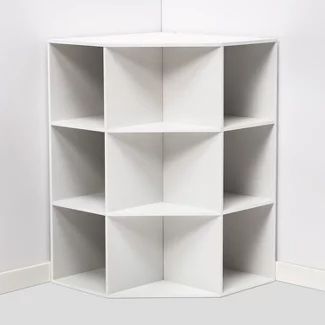 the corner shelf is white in color and has five shelves on each side, with one section open