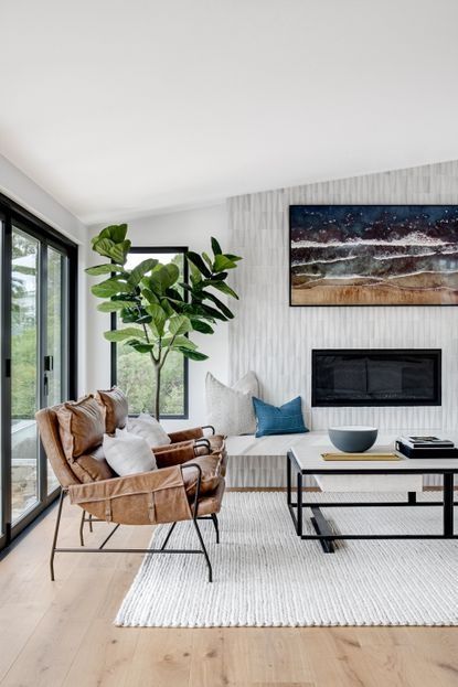 a living room filled with furniture and a flat screen tv mounted to the wall next to a window