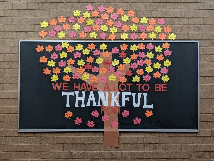 a bulletin board that has been decorated with leaves and the words, we have not to be grateful for