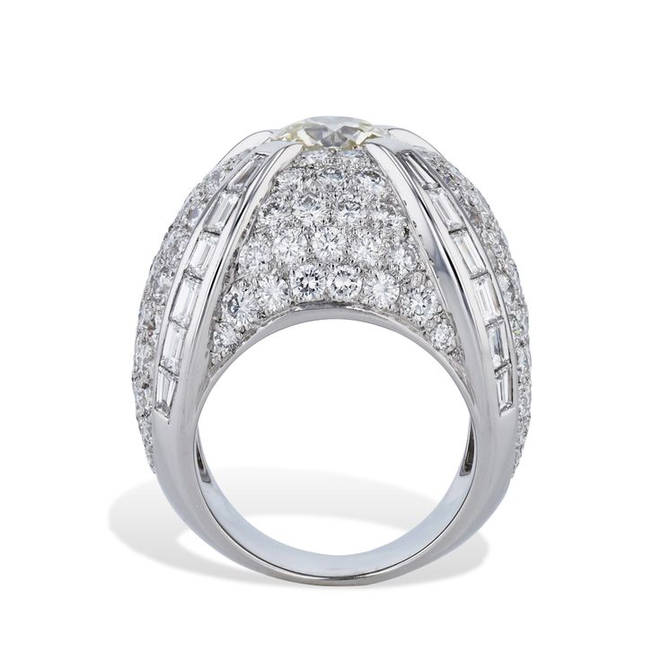 This 18kt White gold French Hallmark Dome Ring is truly breathtaking with its Old European Cut Diamond, plus an awe-inspiring 122pcs of Pave Diamonds and an impressive 24pcs of Baguette Diamonds - all together, this stunning Ring amounts to an eye-catching 6.87ct TW! An Estate Ring of a perfect Size 6. White gold French Hallmark Dome Ring 18kt. White gold Approx. 6.87ct TW Diamonds 1pc Old European Cut Diamond - 1.49ct K-L VS2 ( 7.45x7.43x4.43mm) 122pcs Approx. 4.95ct RBC F/G VS 24pcs Approx 1.9 Estate Rings, Dome Ring, Baguette Diamonds, Domed Ring, European Cut Diamonds, Baguette Diamond, Diamond Sizes, Selling Jewelry, Awe Inspiring