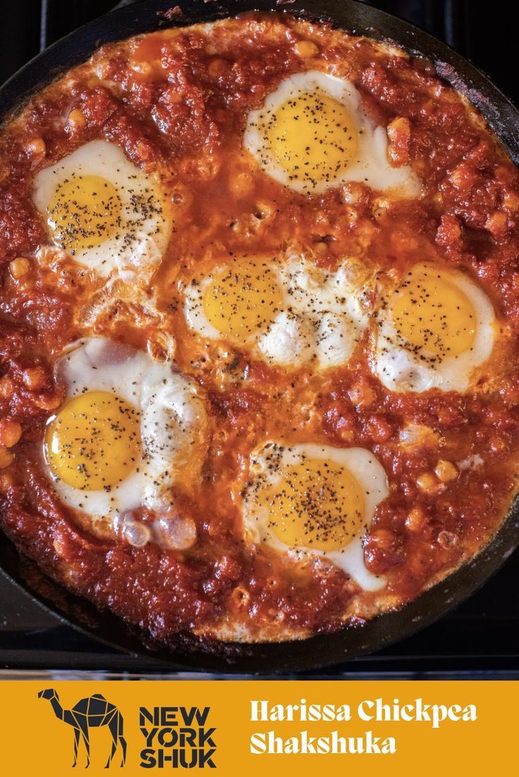 three eggs are on top of the pizza in the skillet, ready to be cooked