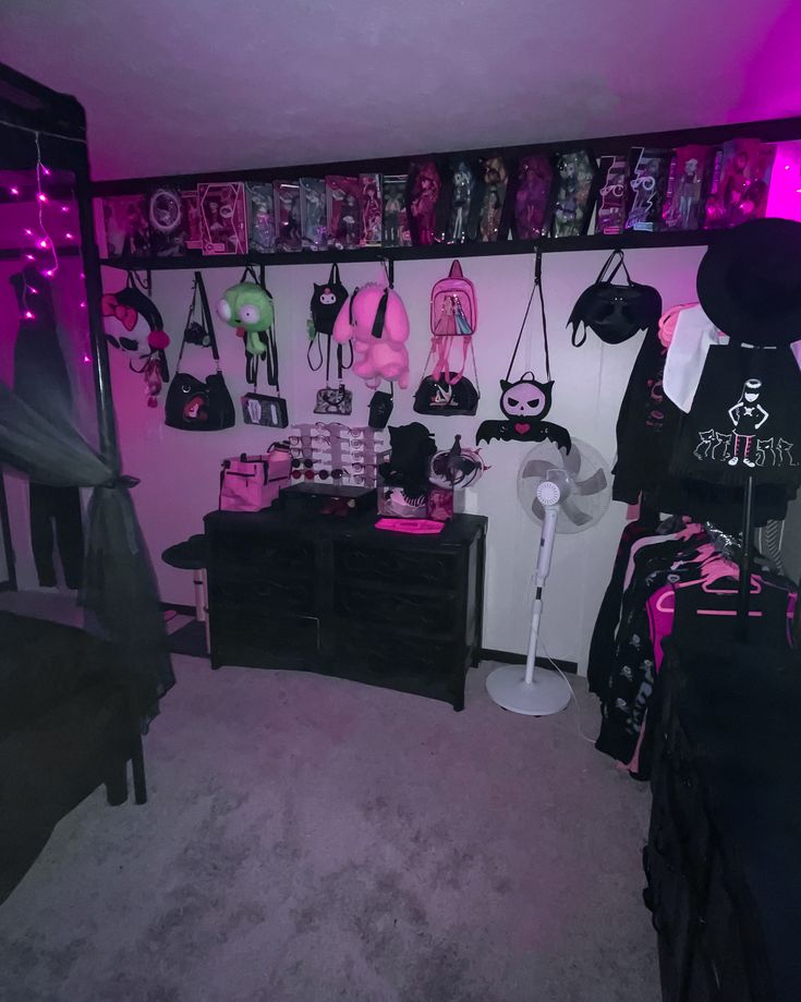 a room filled with lots of bags and purses on the wall next to a bed